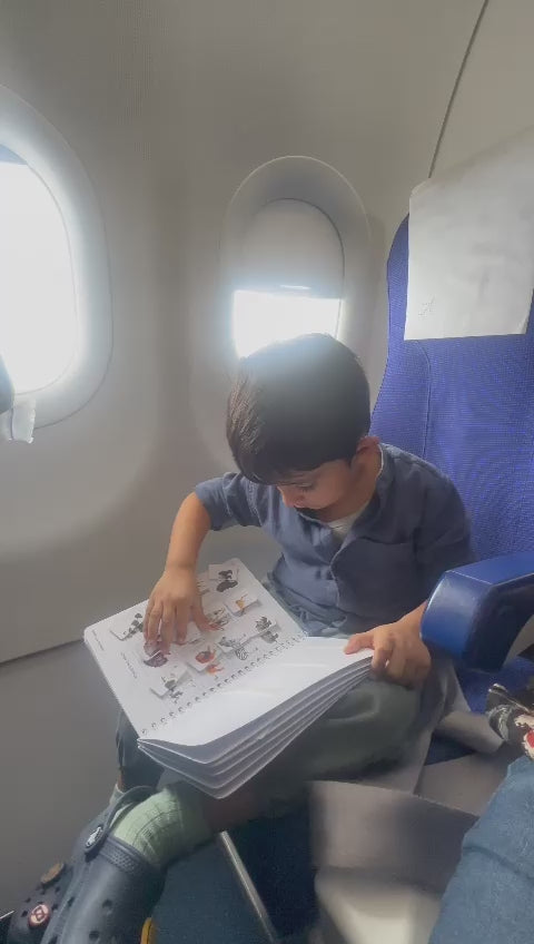 A child travelling on a flight matching the pictures in an activity sheet.