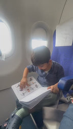 A child travelling on a flight matching the pictures in an activity sheet.